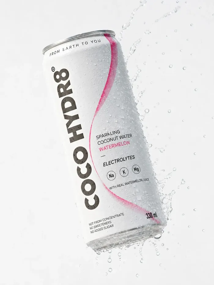 A can of COCO HYDR8 Watermelon tilted mid-air in a splash of water